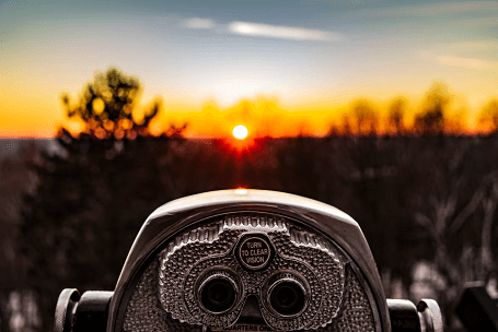 Coin operated binoculars looking at sunrise
